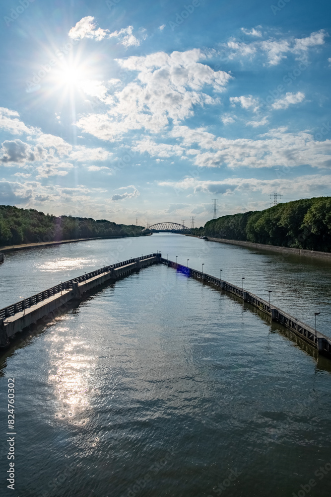 A beautiful river view with a distant bridge under a sunny sky creates a serene and picturesque scene