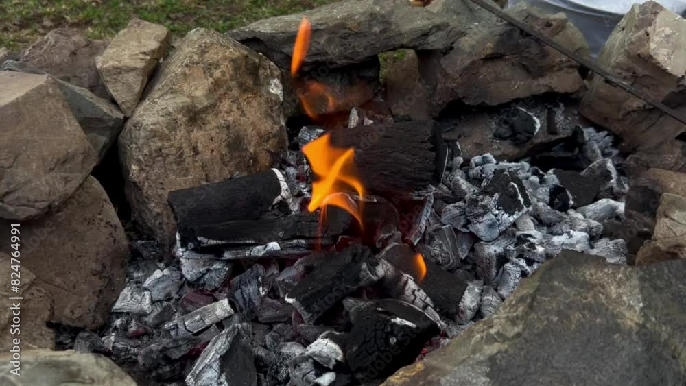 Fire camping and nature with wood-burning flame and survival with wooden charcoal in the forest or woods during an adventure camp. Fire camping and nature with wood-burning flame and survival with wooden charcoal in the forest or woods during an adventure camp.