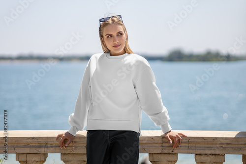 Mockup of a white sweatshirt on a girl in glasses, a pullover with slits on the sides, empty clothes.