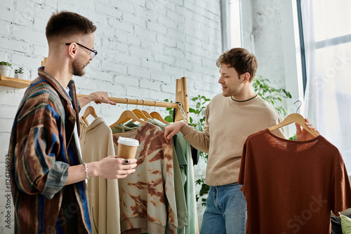 Two men, a gay couple, engaged in creating trendy attire in a designer workshop.