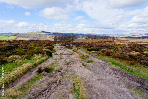 Rock strewn path across rugged Derbyshire moorland