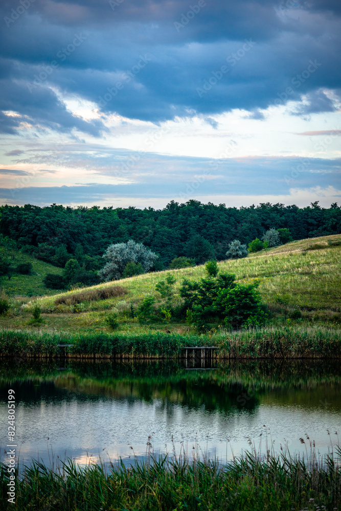 Summer river at morning . Forest on anothe beach. Fog on the water . Green forest . Reflections on the water . Sky over the lake . Trees on beach Summer river at morning . Forest on anothe beach. Fog on the water . Green forest . Reflections on the water . Sky over the lake . Trees on beach