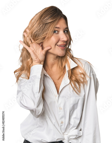 Caucasian blonde woman in studio trying to listening a gossip.