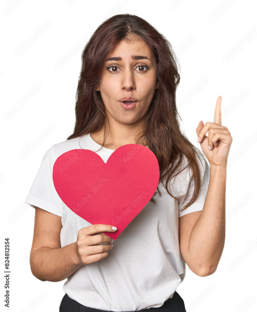 Middle Eastern woman holding paper heart having some great idea, concept of creativity. Middle Eastern woman holding paper heart having some great idea, concept of creativity.