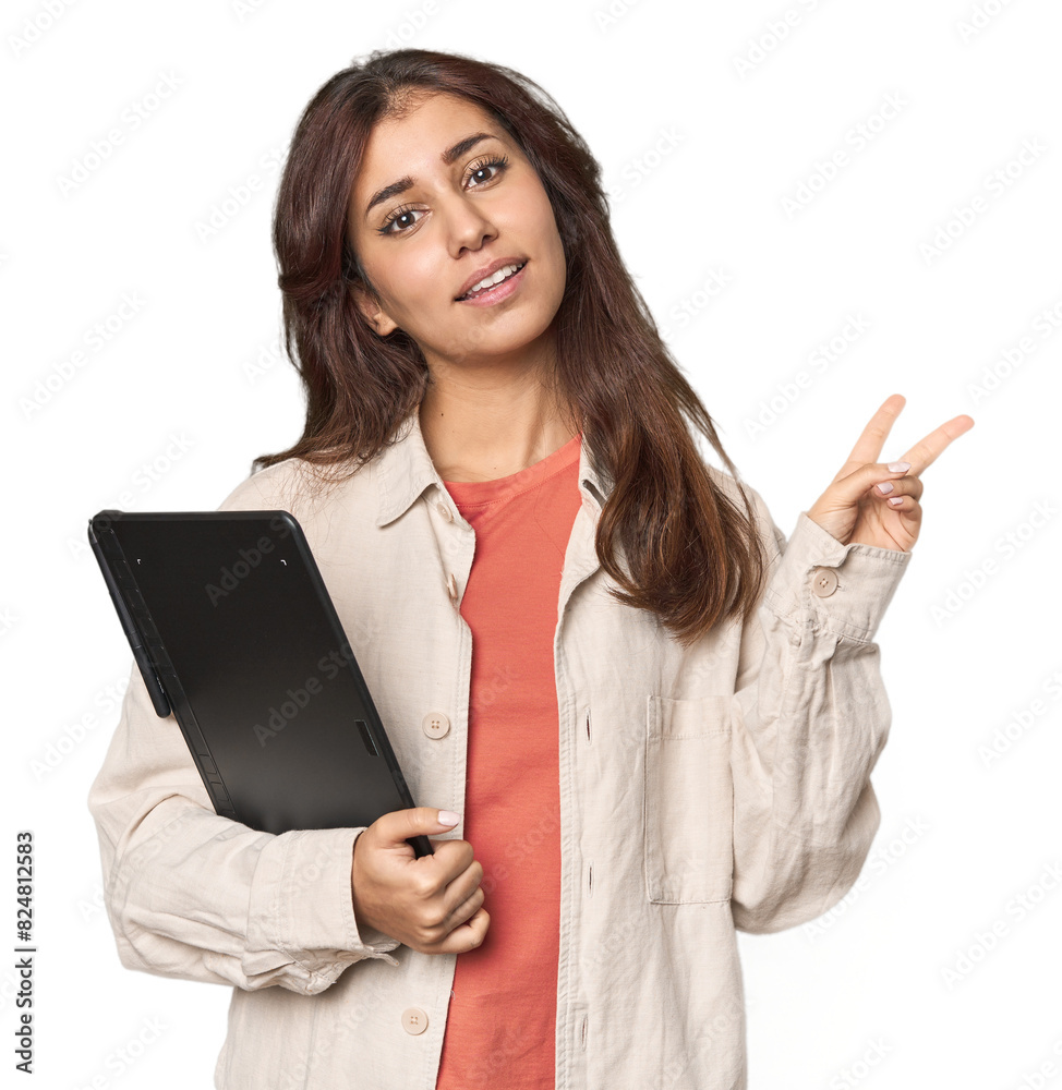 Middle Eastern woman with graphic tablet joyful and carefree showing a peace symbol with fingers. Middle Eastern woman with graphic tablet joyful and carefree showing a peace symbol with fingers.