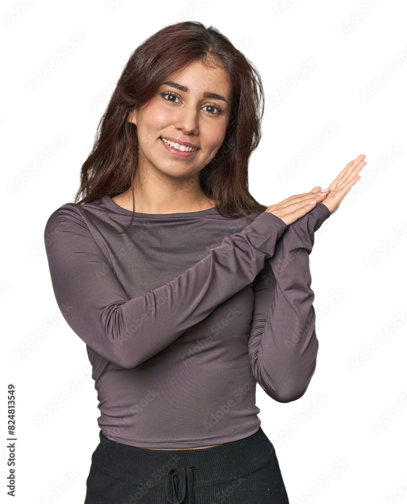 Middle Eastern woman in studio feeling energetic and comfortable, rubbing hands confident. Middle Eastern woman in studio feeling energetic and comfortable, rubbing hands confident.