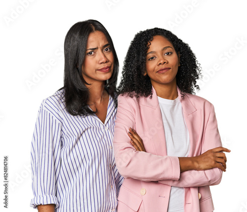 Young Latin businesswomen in studio suspicious, uncertain, examining you.