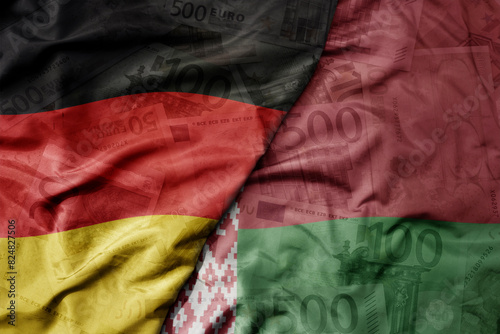big waving realistic national flag of belarus and national flag of germany on a euro money banknotes background. finance concept.