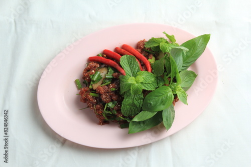 Thai food, Northeastern food, Larb Koi salad, raw beef salad. Northeastern Thai food. Raw meat mixed with spices has a spicy flavor with fresh blood and a bitter taste (called sok lek).