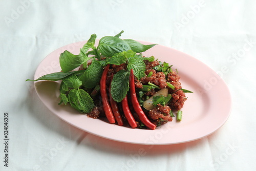 Thai food, Northeastern food, Larb Koi salad, raw beef salad. Northeastern Thai food. Raw meat mixed with spices has a spicy flavor with fresh blood and a bitter taste (called sok lek).