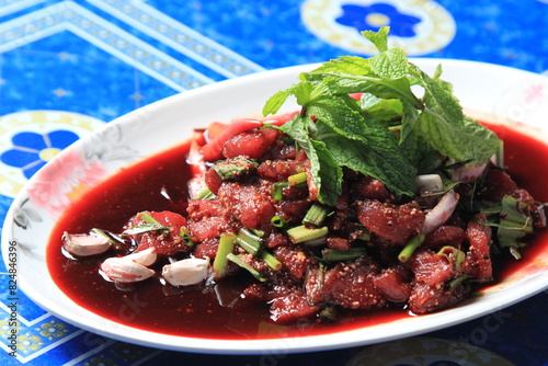 Thai food, Northeastern food, Larb Koi salad, raw beef salad. Northeastern Thai food. Raw meat mixed with spices has a spicy flavor with fresh blood and a bitter taste (called sok lek).