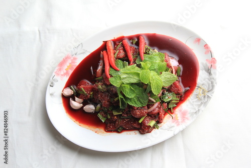 Thai food, Northeastern food, Larb Koi salad, raw beef salad. Northeastern Thai food. Raw meat mixed with spices has a spicy flavor with fresh blood and a bitter taste (called sok lek).