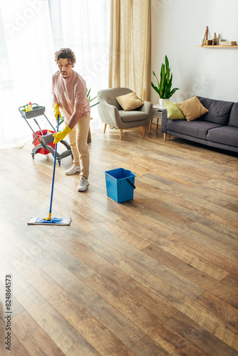 Man elegantly mopping living room floor.