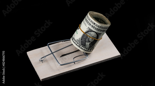 A stack of 1 US dollar bills and a mousetrap on a black background