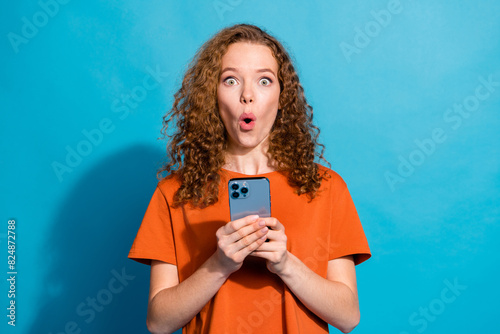Photo of amazed girl hold use smart gadget isolated blue color background