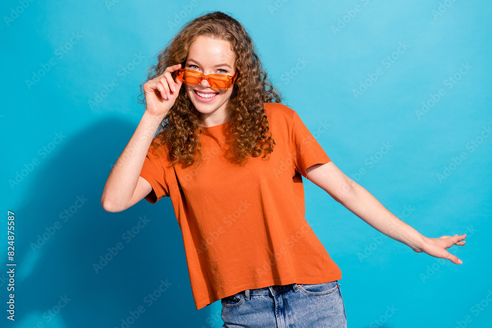 Photo of positive smiling girl touch sunglass look isolated blue color background Photo of positive smiling girl touch sunglass look isolated blue color background