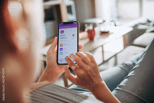 Woman using mobile banking app on smartphone at home photo