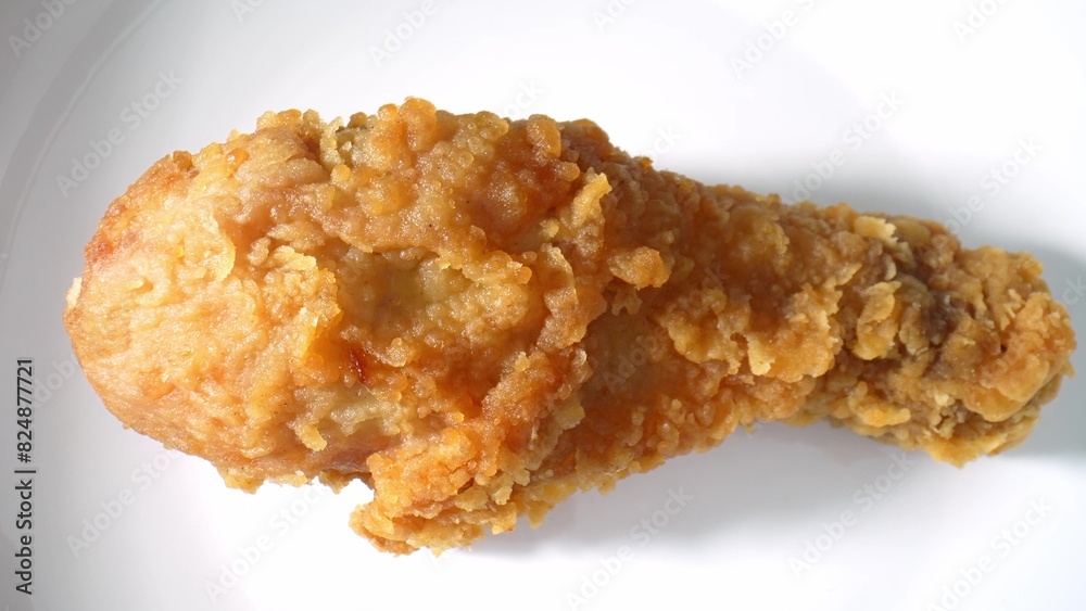 Extreme close-up reveals crispy, golden hot fried chicken glistening with flavorful spices on a white plate. Fast food background.
Extreme close-up reveals crispy, golden hot fried chicken glistening with flavorful spices on a white plate. Fast food background.
