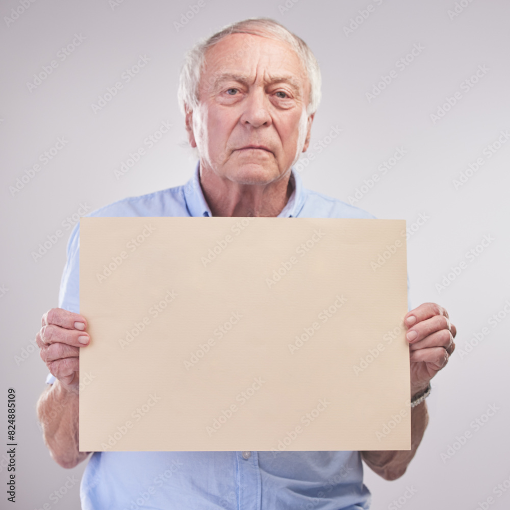 Sign, mockup and senior man with poster with pension info or retirement in white background. Elderly, portrait and stress with advice on cardboard in studio for opinion feedback, announcement or news