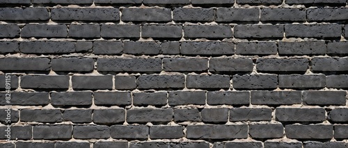 Close-up view of a Monochrome black painted brick wall texture as a background or wallpaper 