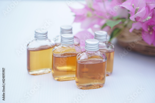 Transparent glass bottles of homemade herbal massage oil. Concept, Thai local wisdom to use fragrant medicinal herbs to make  massage oil for aromatherapy and relaxation.     