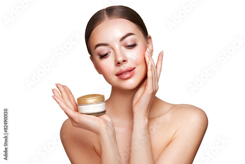 Beauty woman applying cream on her face. Young woman with clean fresh skin. Model with a jar of face cream