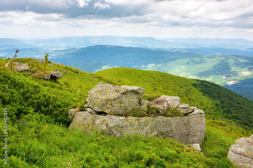 boulder on the grassy alpine slope. carpathian mountains in summer on a cloudy day boulder on the grassy alpine slope. carpathian mountains in summer on a cloudy day