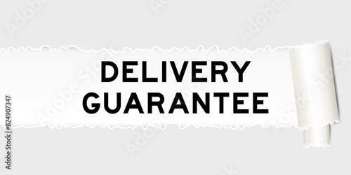 Ripped gray paper background that have word delivery guarantee under torn part