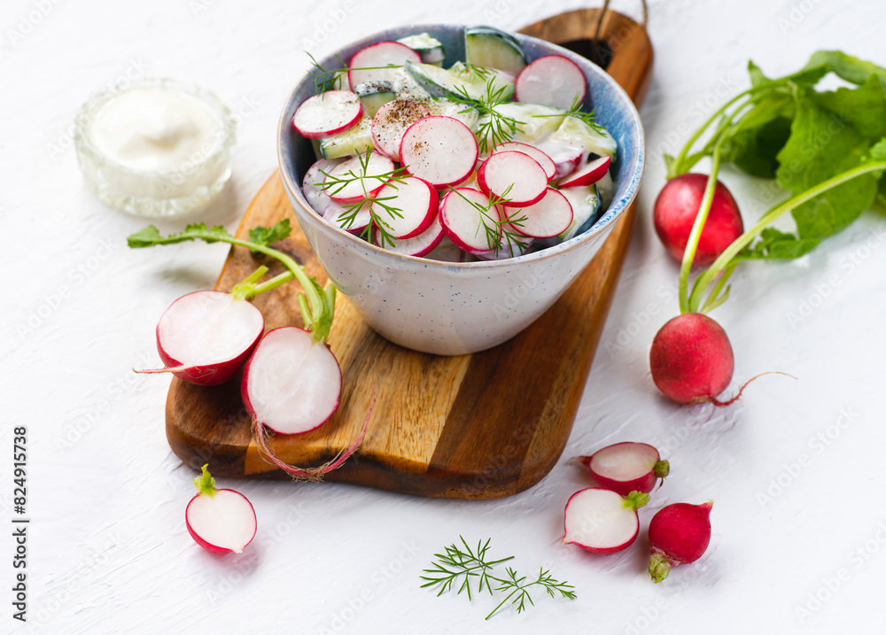 Dietary northern summer salad with cucumbers, radishes and natural yoghurt or sour cream, healthy summer low-calorie recipes, Scandinavian and Eastern European cuisine. Estonian salads Dietary northern summer salad with cucumbers, radishes and natural yoghurt or sour cream, healthy summer low-calorie recipes, Scandinavian and Eastern European cuisine. Estonian salads