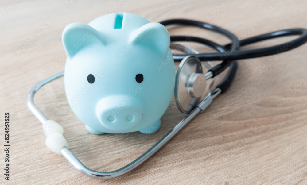 Piggy bank with medical equipment on the table medical concepts and health insurance. Piggy bank with medical equipment on the table medical concepts and health insurance.