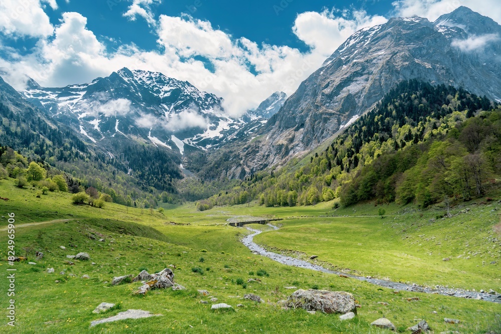 View of some mountains with some snow on top. Hiking in the mountain in spring. Route of the Artiga De Lin in the Aran Valley, Catalonia, Spain.
