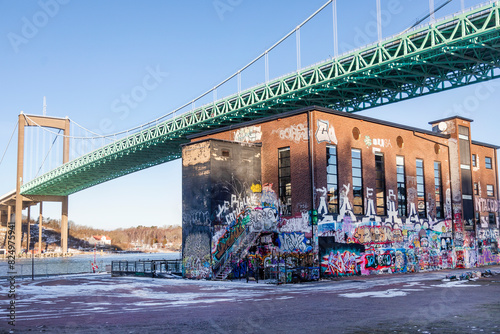 Graffiti on building wall with Alvsborg suspension bridge in city photo