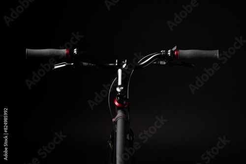 bicycle handlebar, bike isolated on black studio backdrop, bike part details