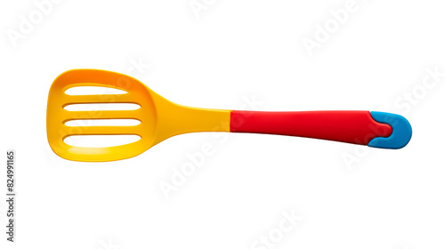 A yellow and red spatula with a red handle laying on a countertop