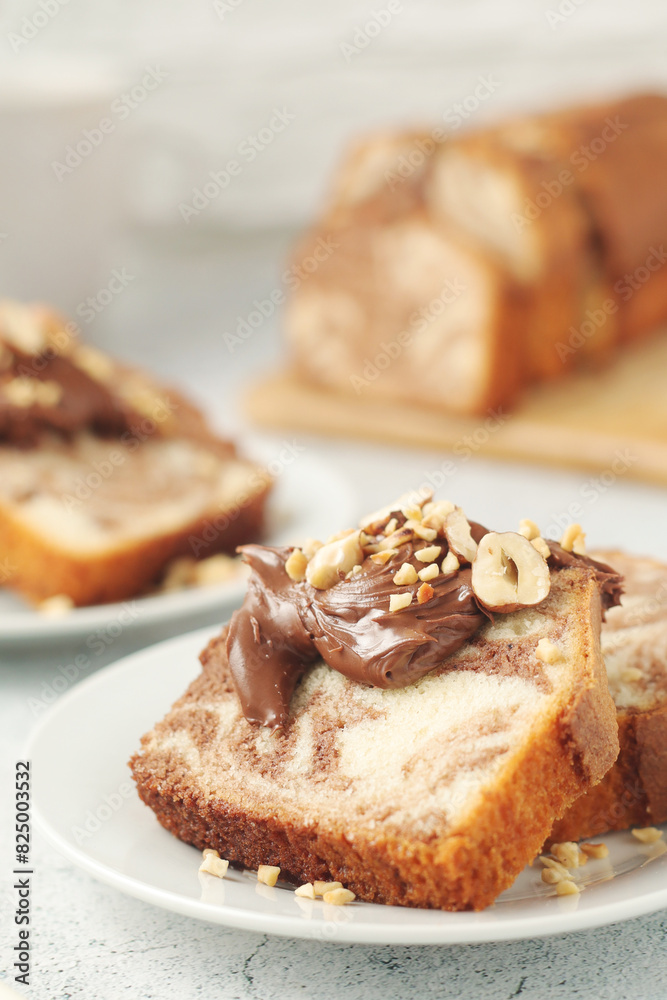 A piece of marble biscuit with chocolate cream and nuts