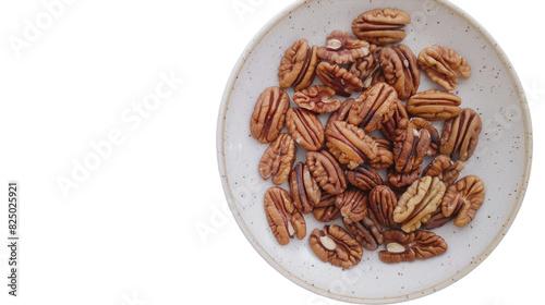 A white bowl filled with various nuts placed on top of a wooden table