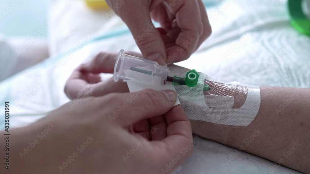 Hospital Nursing Care - Blood Sample Bottle Attached to Patient's Hand, Nurse Securing Straps Hospital Nursing Care - Blood Sample Bottle Attached to Patient's Hand, Nurse Securing Straps