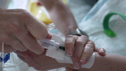 Nurse hand applying medical drip into Patient s hand with IV catheter closeup. hospital equipment and routine