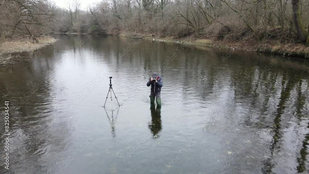 photographer at work in the middle of the river in the Ticino park photographer at work in the middle of the river in the Ticino park