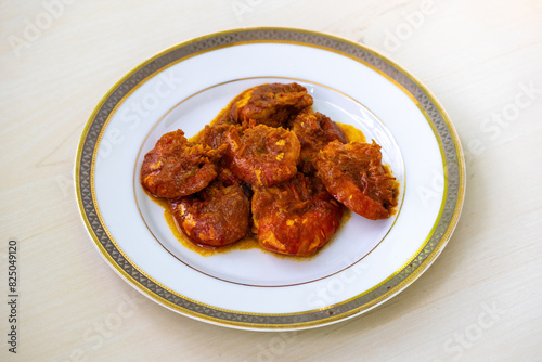 Tasty Bengali food shrimp fish curry or chingri bhuna served on a white plate. Chingri vuna or prawn curry is a Bangladeshi-style dish with spicy gravy. photo