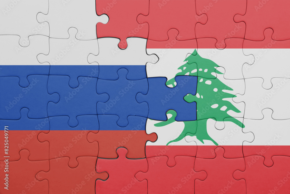 puzzle with the colourful national flag of lebanon and flag of russia. puzzle with the colourful national flag of lebanon and flag of russia.