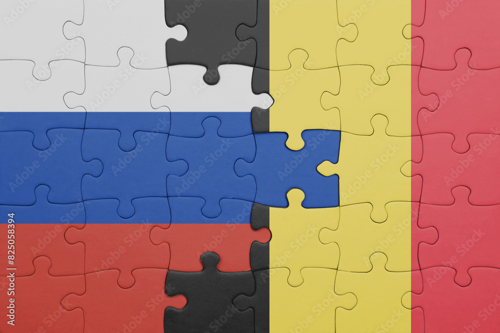 puzzle with the colourful national flag of belgium and flag of russia. puzzle with the colourful national flag of belgium and flag of russia.