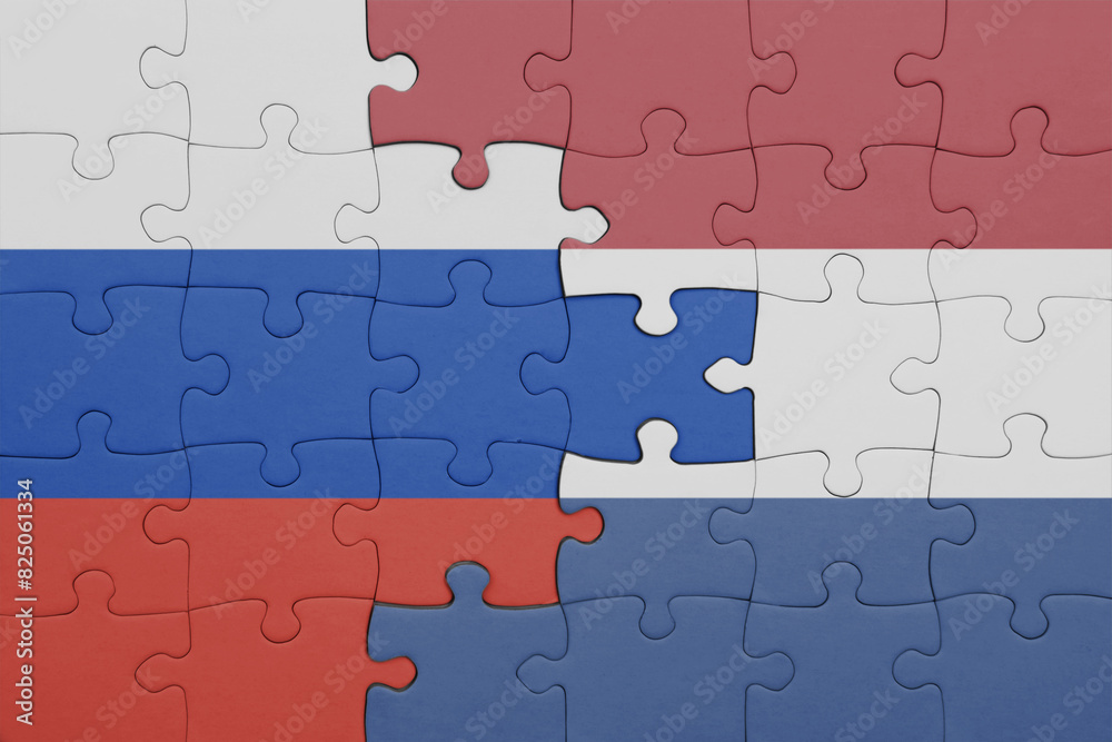 puzzle with the colourful national flag of netherlands and flag of russia. puzzle with the colourful national flag of netherlands and flag of russia.