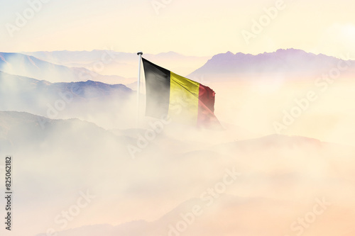 Belgium flag disappears in beautiful clouds with fog.
