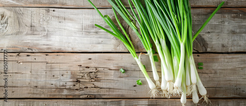 Bunch of spring onions on a rustic wooden table  top view  emphasizing the fresh and organic nature