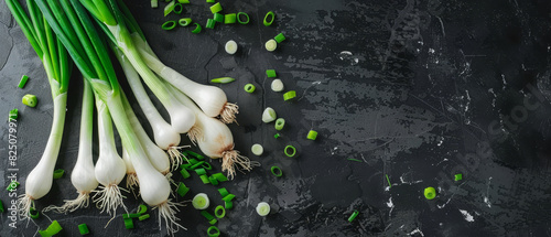 Fresh spring onions on a dark slate background photo