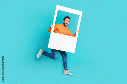 Photo of cheerful crazy man wear trendy clothes hands hold white frame cadre isolated on cyan color background