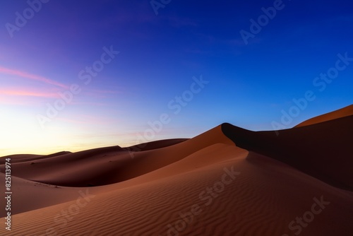 view of the sand dunes at Erg Chebbi in Morocco at sunset