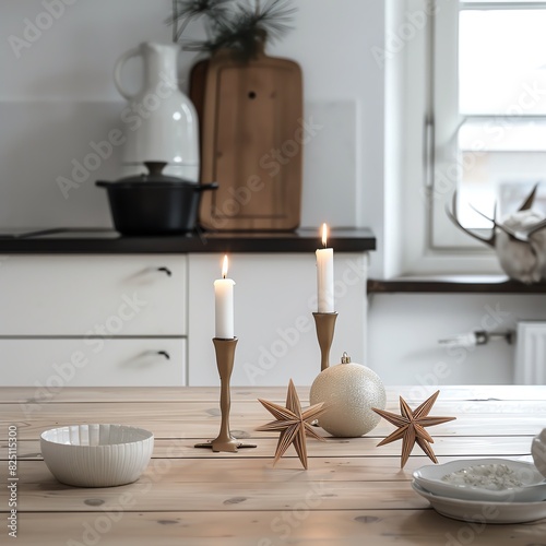 Cozy kitchen with a wooden table featuring candles, Christmas ornaments, and a serene, minimalist decoration.