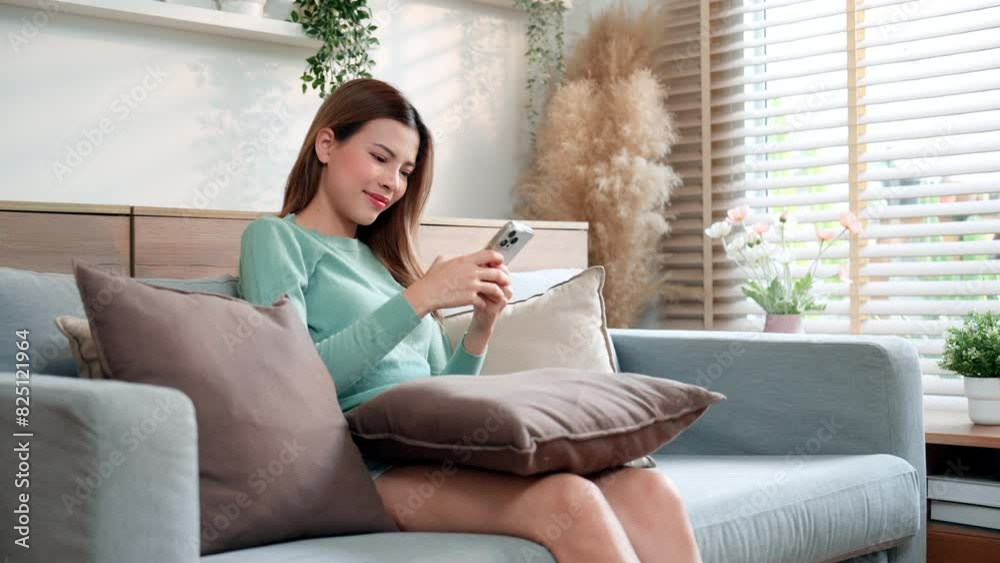 A woman using chat message app on smartphone, in response to communication. A woman using chat message app on smartphone, in response to communication.